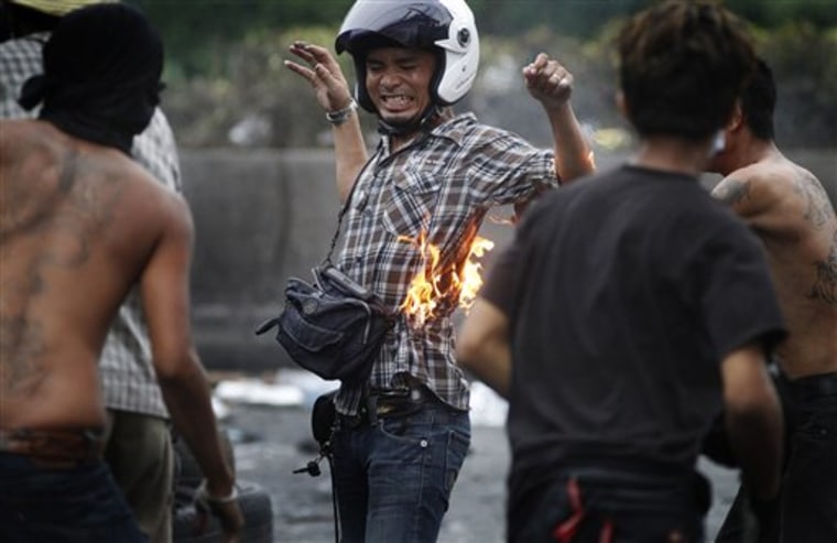 An anti-government protester accidentally burned himself while throwing a molotov cocktail at Thai soldiers on Tuesday in Bangkok, Thailand.